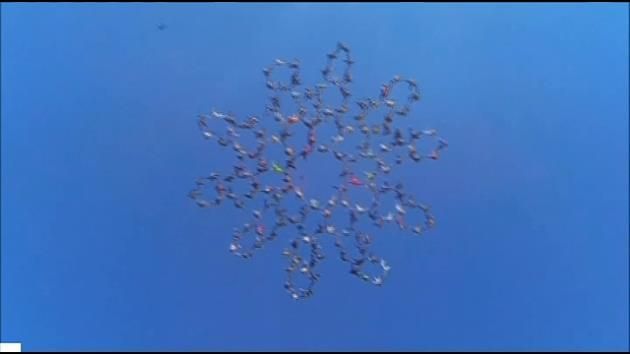 164 skydivers smash head-down world record in Illinois