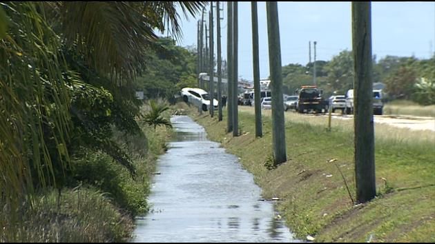 Man found fatally shot inside car submerged in canal; 3 injured