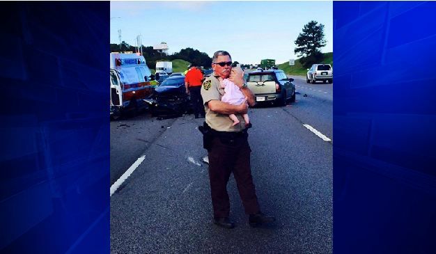 Deputy comforts baby at the scene of Alabama crash