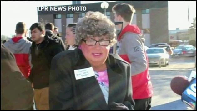 Middle-aged man dresses as old woman for official's photo op